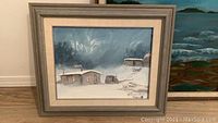 Front view of framed winter ice fishing scene painting signed H. Beaudry