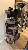 Full view of golf bag standing on floor showing headcovers for driver and woods