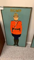Full view of framed acrylic painting depicting an RCMP officer in red uniform and hat with blue background, text 'RCMP' at top.