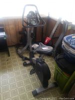 Full side view of Pro-Form stationary exercise bike showing seat, pedals, frame, and electronic console.