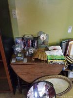 Full lot on wooden drop-leaf table against yellow wall, showing all items