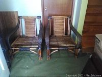 Front view of two wicker patio chairs with bamboo slat seats and backs, showing their overall shape and condition.