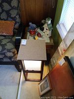 Top view of end table showing wood frame, tile surface, and surrounding furniture