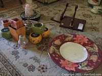 Lot contents including wood shelves, Halloween themed solar lights, surge protector, decorative bowl, fountain, candle with glass shade