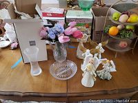 Overview photo showing Mikasa crystal vase, two angel figurines, artificial flowers, and glass cut dish arranged on table.