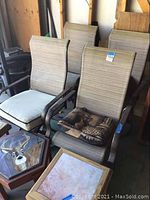 Overview of four patio chairs and two side tables grouped in garage