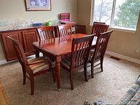 Full view of table with six chairs in dining room