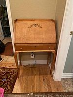 Front view of slant top desk showing fall-front and single drawer