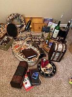 Full view of wine-related decor and accessories arranged on carpet, showing cork wreath, basket of corks, decorative trays and boxes, books, and large wine bottle.