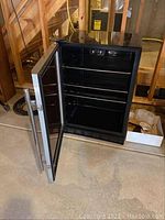 Front view with door open showing empty interior and wire shelves