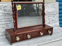 Front view of antique wooden dresser top shaving mirror vanity stand, showing three drawers with glass knobs and mounted rectangular mirror.