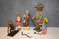 Full lot of five primitive style figures displayed with detached axe and snake piece