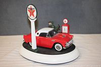 Full view of the mechanical bank showing the red and white car, Texaco sign, and gas pump with attendant figure missing right hand