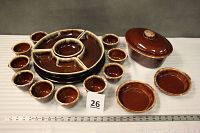 View of entire Hull brown drip stoneware set including oval bowl with lid, small bowls/onion soup crocks, medium bowls, and Pfaltzgraff lazy Susan with center and sectional bowls