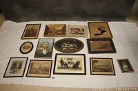 Overview of all 13 framed antique and vintage art pieces laid out on a white surface, showing variety of artwork and frames, including prints, oils, and silhouette art.