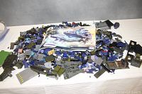 Large assortment of loose Mega Bloks Halo pieces spread on a surface with two instruction booklets visible.