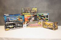 Full lot showing all 7 toys in original boxes including vehicles and tracks.