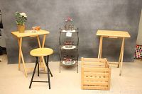 Photo of the wooden folding tea tables, folding stool/table, wooden crate, and metal plant stand with some of the baskets and flower pots on display