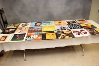 Full spread of 21 vinyl LP covers showing a variety of jazz, big band, and instrumental music albums arranged on a table.