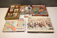 Group photo of all 6 puzzle boxes with various themes and sizes, showing the full assortment included in the lot.