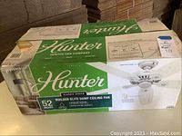 Hunter Builder Elite Damp Ceiling Fan boxed with clear product label and features.