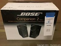 Photo of the Bose Companion 2 Series II speaker system in unopened original packaging showing brand and model.