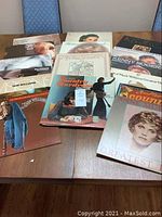 Full collection of vintage country LP records displayed on a table, featuring multiple artists.