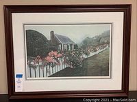 Full view of the framed watercolor print showing the entire artwork with house, picket fence, and flower bushes