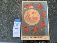 Front cover of 1952 St. Louis Cardinals souvenir program featuring cartoon cardinal mascots around a baseball with team name and year.