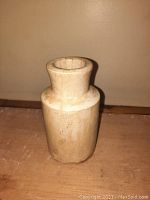 Stoneware cylindrical crock shown upright with visible natural color and aged surface.