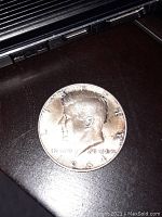 Obverse of 1964 Kennedy half dollar showing John F. Kennedy profile, date 1964, inscriptions LIBERTY and IN GOD WE TRUST.