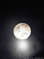 Obverse side of the 1966 Canadian silver dollar coin showing Queen Elizabeth II.