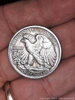 Reverse side of the 1935 D silver half dollar coin showing an eagle, 'UNITED STATES OF AMERICA', 'E PLURIBUS UNUM', and 'HALF DOLLAR'.