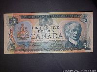 Front of the 1979 Canadian five dollar bill showing portrait, coat of arms, and bank identification.