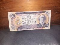 Front side of Canadian $10 bill showing Sir John A. Macdonald portrait and denomination details.