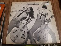 Front cover of the Ted Nugent 'Here It Is' vinyl record album, showing the artist playing guitar and posing in black and white photography.