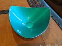 Triangular bowl with vibrant green enamel interior and silverplated exterior