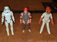 Three vintage Star Wars figures standing, showing front view and condition.