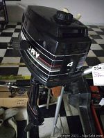 Mercury black outboard motor showing top cowling with '4' horsepower marking