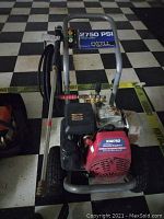 Front and top view of Excell 2750 PSI pressure washer with Honda engine and hose attachment.