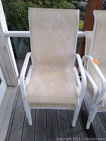 Single white metal frame mesh sling patio chair front view