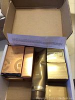 Open white box showing two eye serum boxes, one slender serum box side, metallic tube and two cube boxes