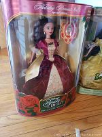 Full view of Holiday Princess Belle Barbie in burgundy and gold gown in original box