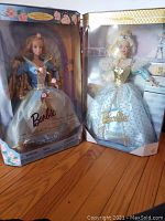 Two Barbie dolls in original boxes standing side by side, Sleeping Beauty and Cinderella