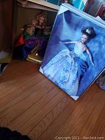 Both Barbies in original boxes; Midnight Princess box is open showing doll, Reflection of Light Barbie visible through clear box cover