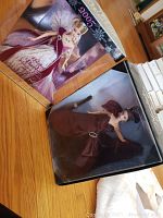 Two boxed collector Barbie dolls on wooden floor, one the 2005 Holiday Barbie and the other Moonlight Waltz Barbie.