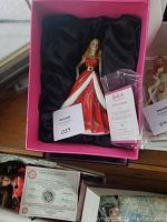 Holiday Barbie figurine in presentation box with satin lining and certificate of authenticity visible