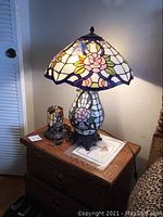 Large Tiffany style table lamp and small accent lamp on wooden nightstand