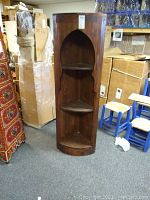 Full front view of the Moroccan wood corner shelf unit showing the three shelves and decorative arched top shelf opening.