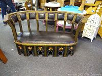 Wide angle photo showing full Moroccan loveseat with curved back and floral painted wood details.
